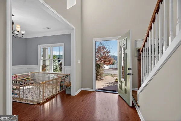 a view of an entryway with wooden floor and windows
