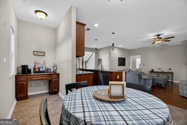 a living room with furniture a dining table and kitchen view