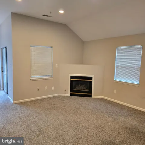 a view of an empty room with a fireplace