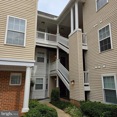 a view of a house with a yard and balcony