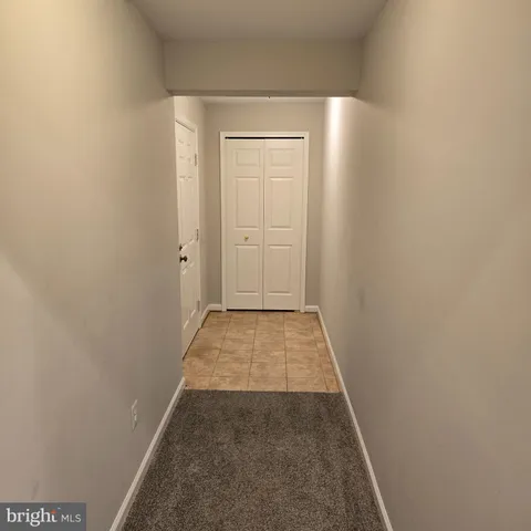 a view of hallway with wooden floor