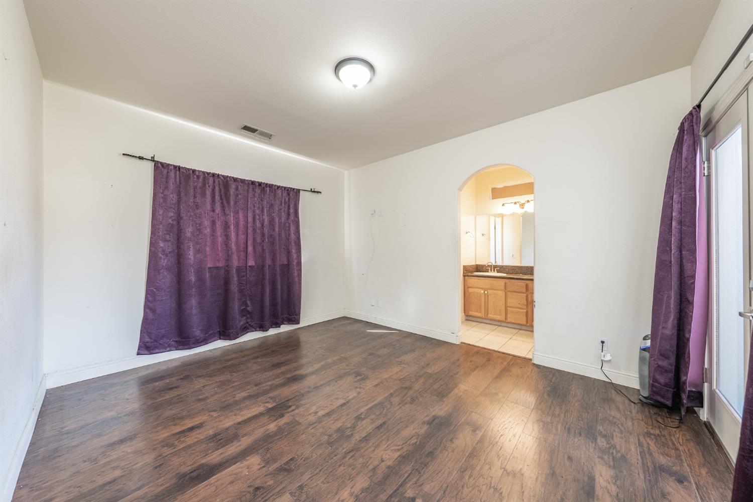 2727 Pear Tree Drive Madera, CA 93637 - Photo 15 of 36 a view of a room with wooden floor staircase and a bathroom