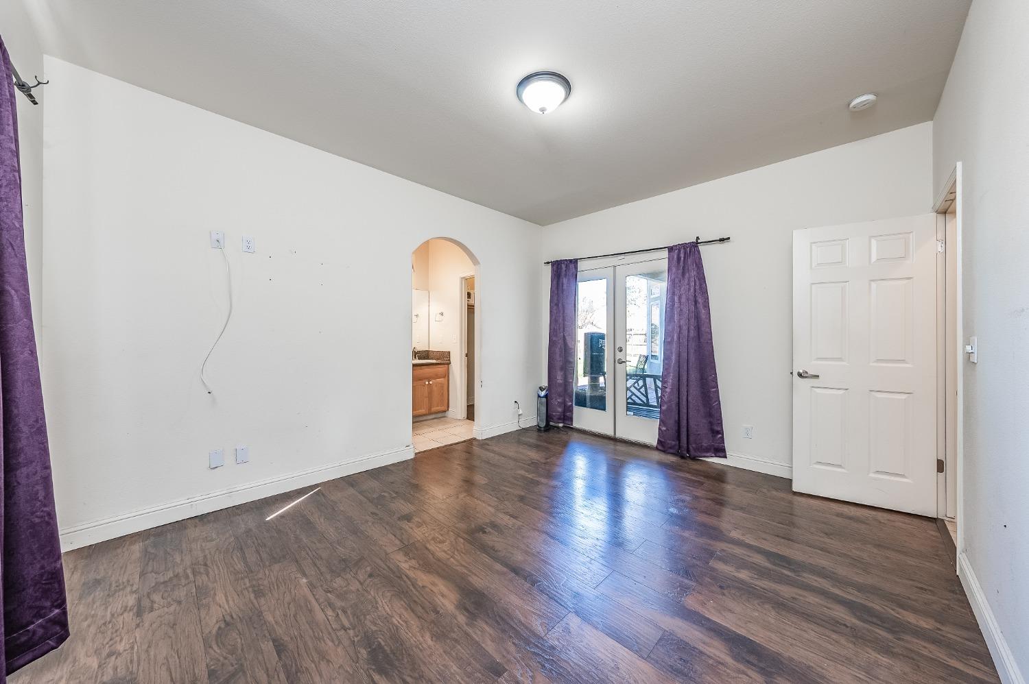 2727 Pear Tree Drive Madera, CA 93637 - Photo 16 of 36 an empty room with wooden floor and windows
