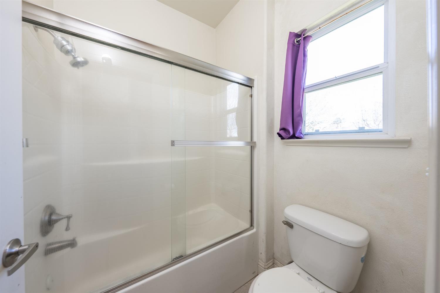 2727 Pear Tree Drive Madera, CA 93637 - Photo 17 of 36 a white toilet sitting next to a bath tub shower