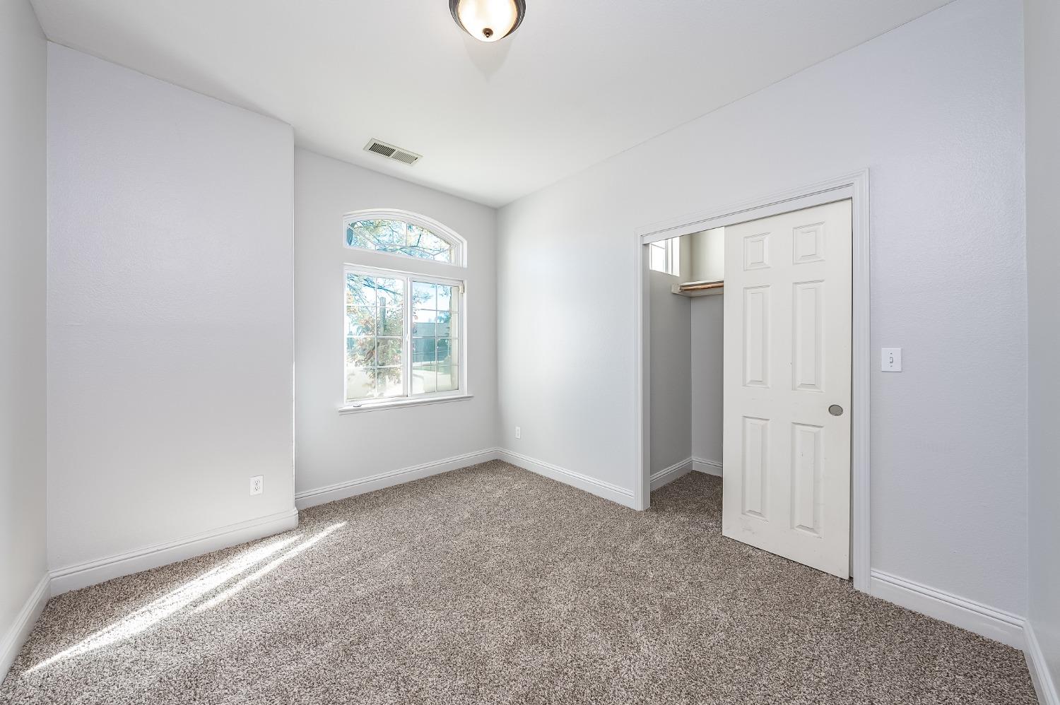2727 Pear Tree Drive Madera, CA 93637 - Photo 22 of 36 an empty room with windows and closet