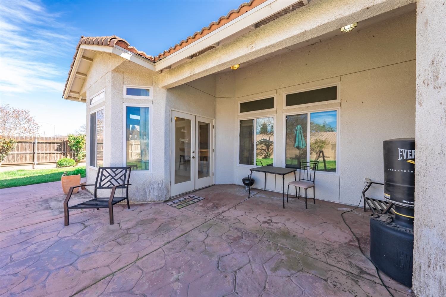 2727 Pear Tree Drive Madera, CA 93637 - Photo 24 of 36 a living room with furniture and a floor to ceiling window