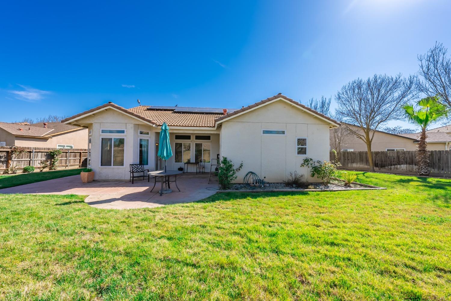2727 Pear Tree Drive Madera, CA 93637 - Photo 25 of 36 a view of a house with a patio and a yard
