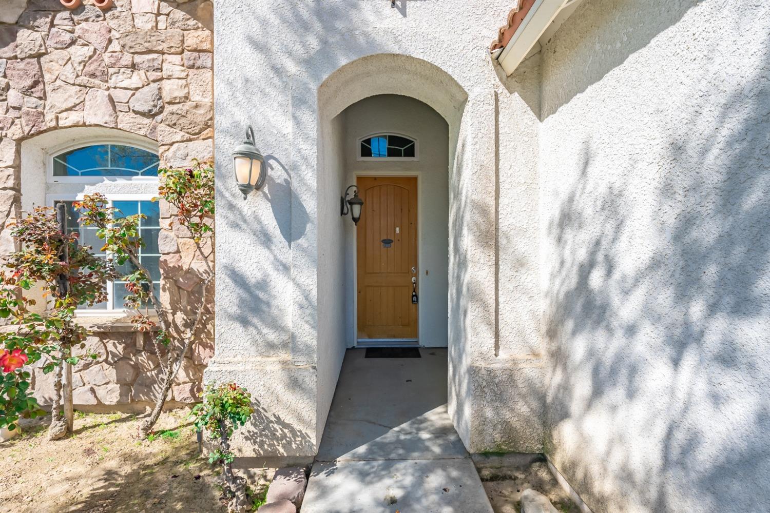 2727 Pear Tree Drive Madera, CA 93637 - Photo 3 of 36 a view of a brick house with a door