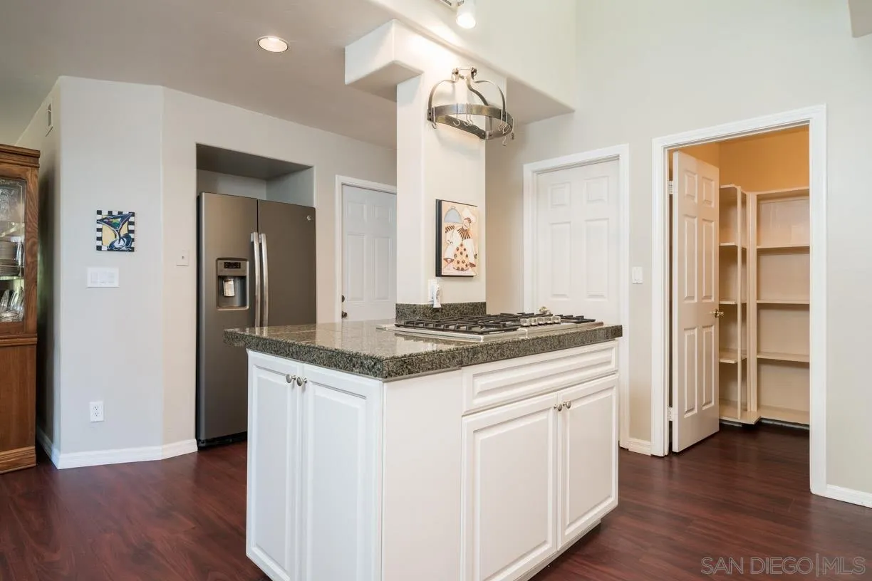 2310 Cordero Road Del Mar, CA 92014 - Photo 11 of 25 a kitchen with a stove and wooden floor