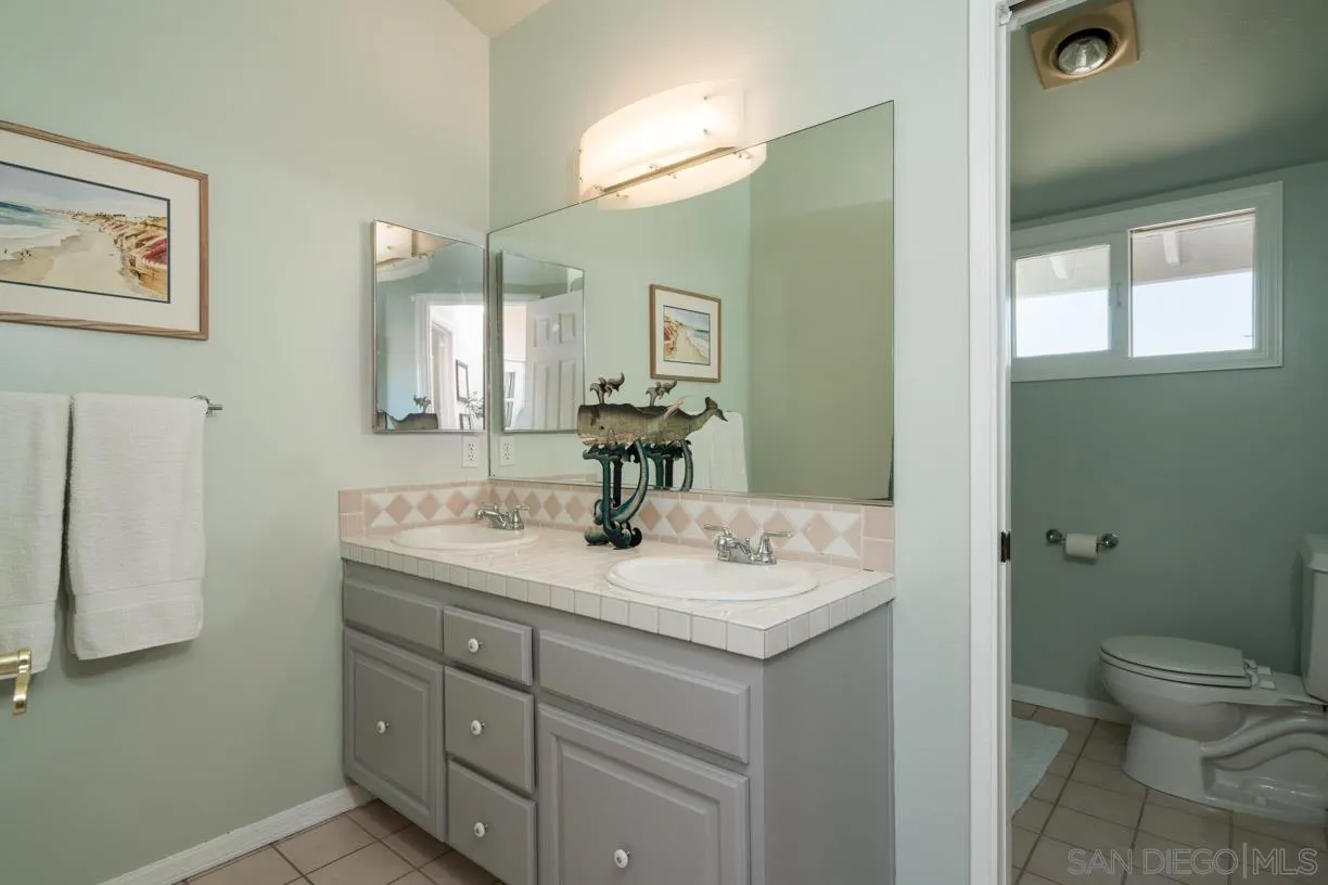 2310 Cordero Road Del Mar, CA 92014 - Photo 21 of 25 a bathroom with a sink toilet and mirror