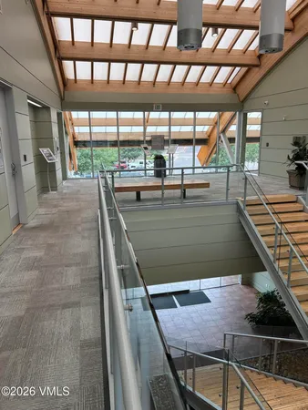 a view of a balcony with floor to ceiling windows with wooden floor