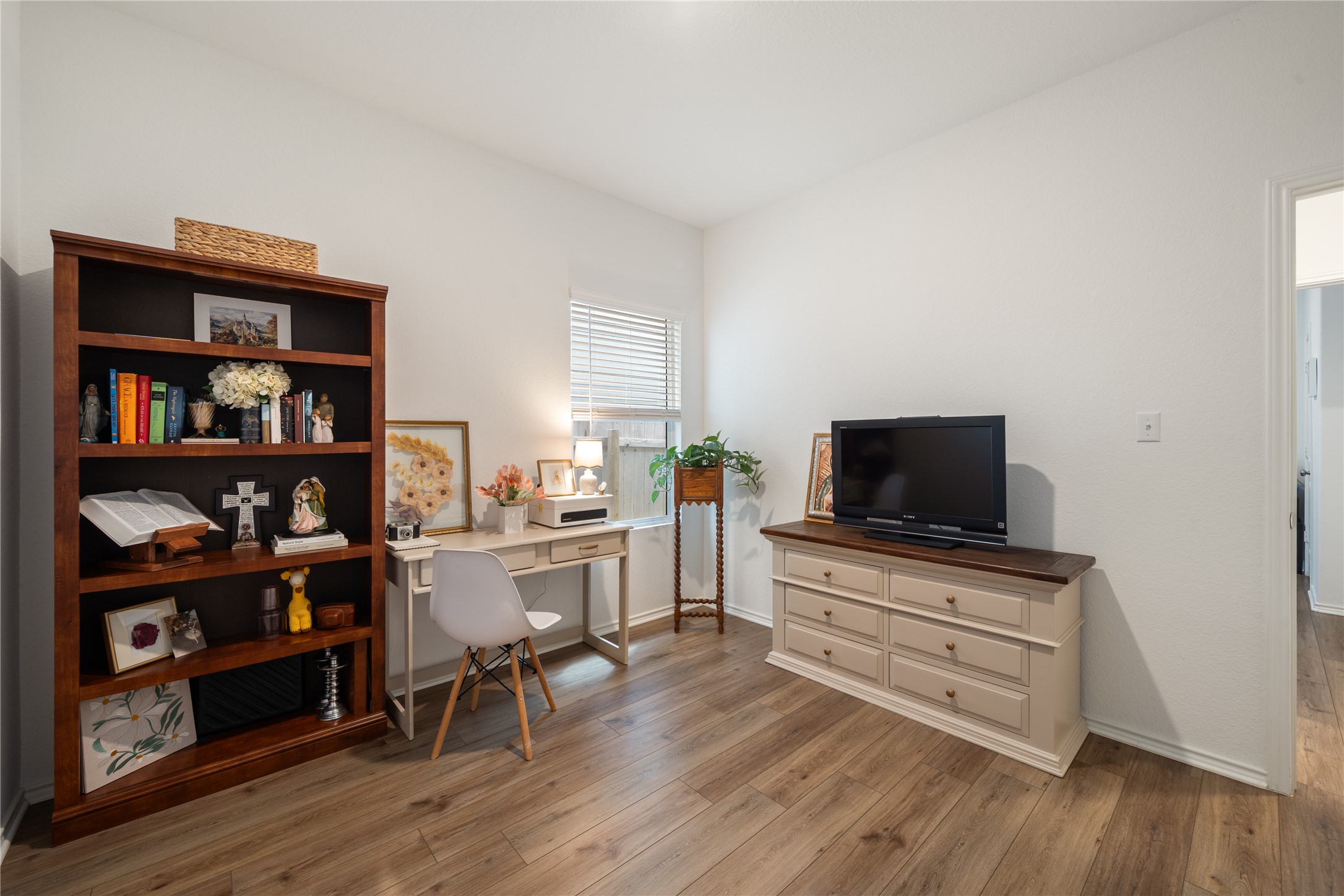 14404 Berning Road Manor, TX 78653 - Photo 27 of 38 A quiet room featuring rich wood flooring and a bright window, perfect for a dedicated home office or flexible living space.