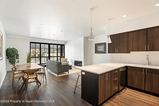 a kitchen with a table chairs sink and cabinets