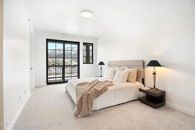 a spacious bedroom with a bed and a window