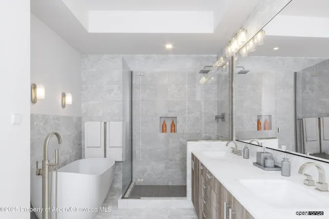 a bathroom with a double vanity sink mirror double and shower