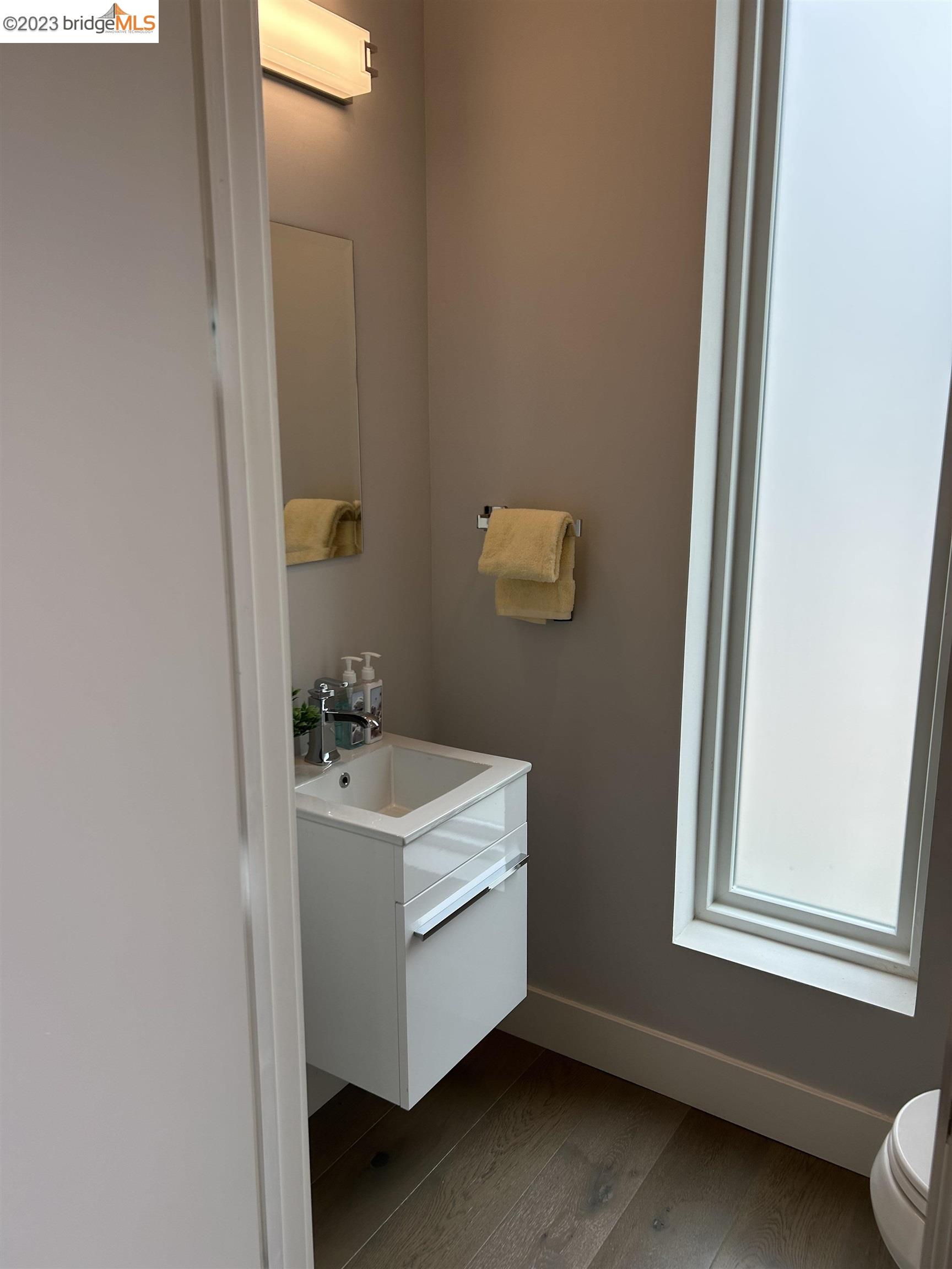 1677 12th Street Oakland, CA 94607 - Photo 11 of 15 a bathroom with a sink mirror and window