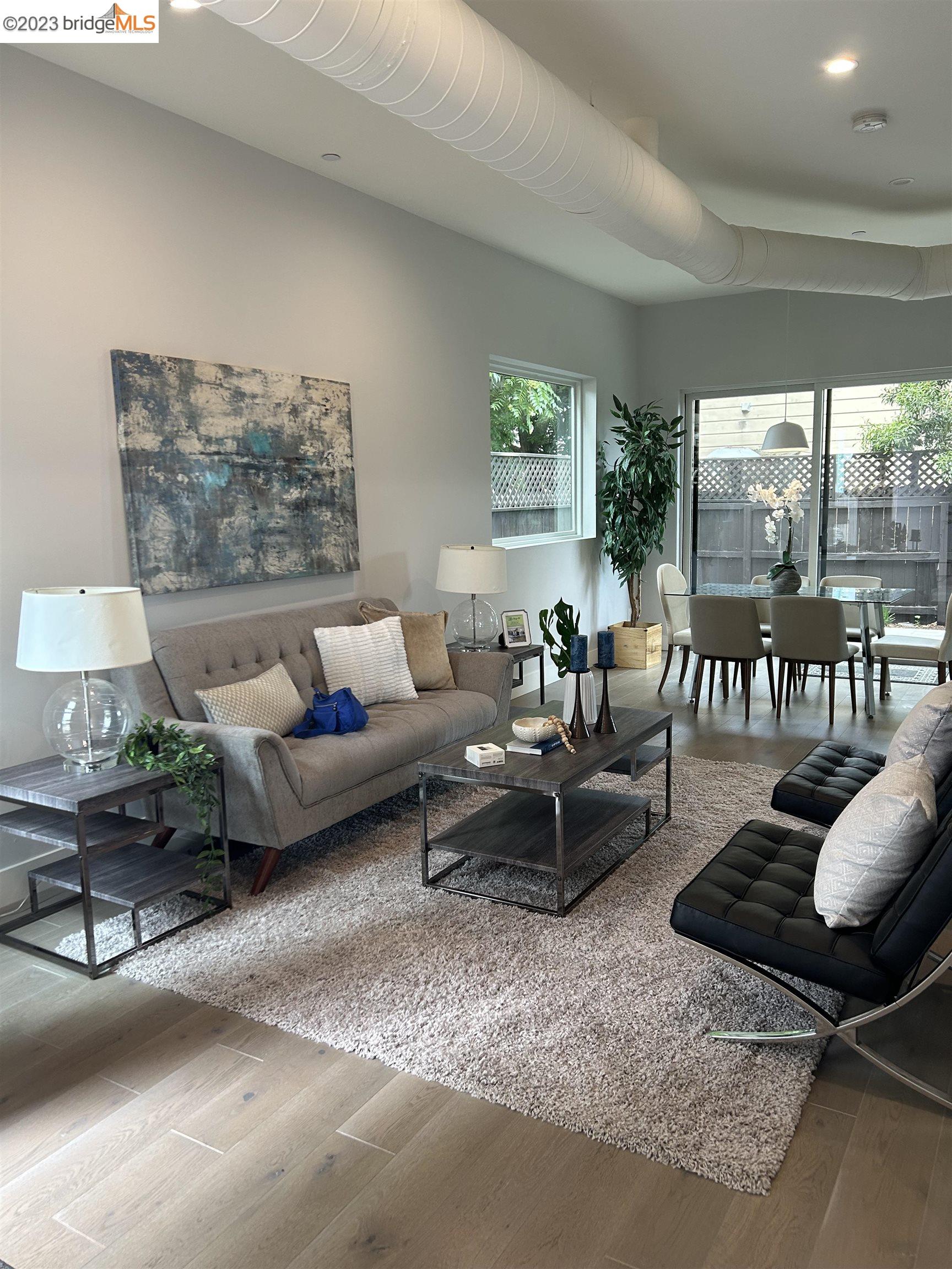 1677 12th Street Oakland, CA 94607 - Photo 2 of 15 a living room with furniture and a large window