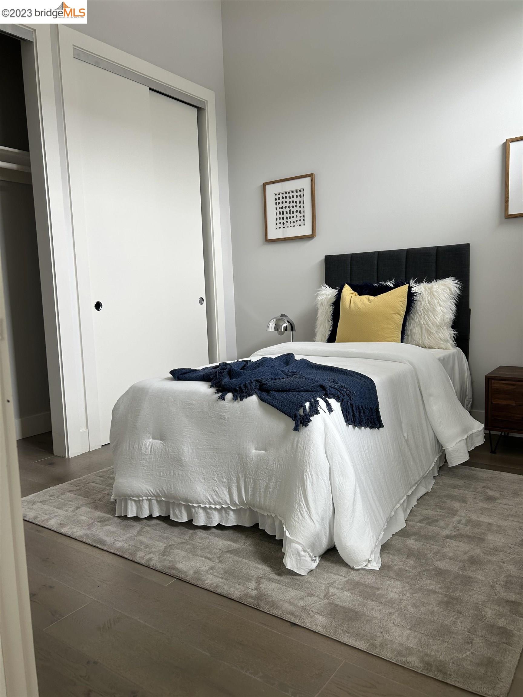 1677 12th Street Oakland, CA 94607 - Photo 5 of 15 a spacious bedroom with a bed and a window