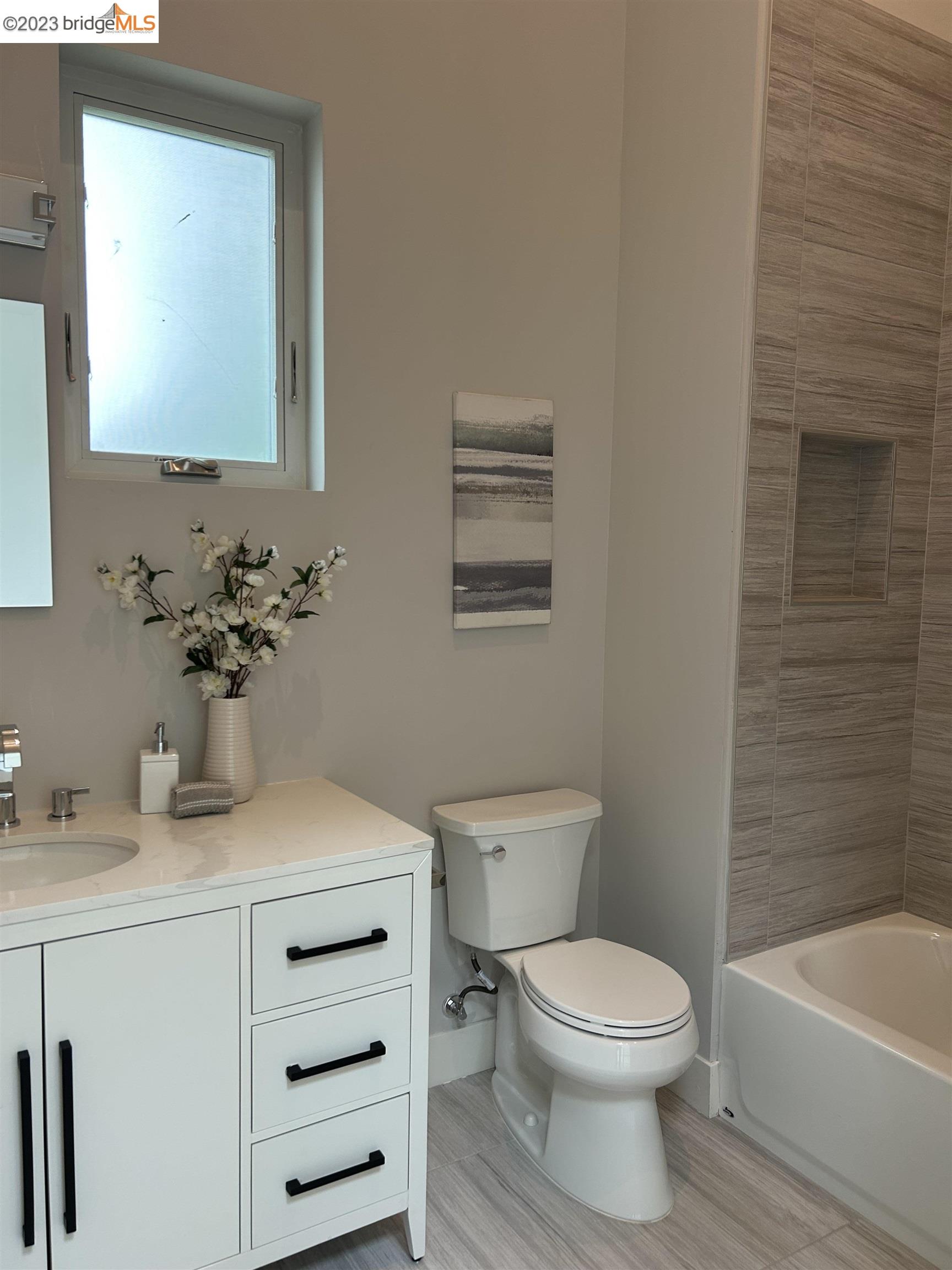 1677 12th Street Oakland, CA 94607 - Photo 6 of 15 a bathroom with a sink a toilet and mirror