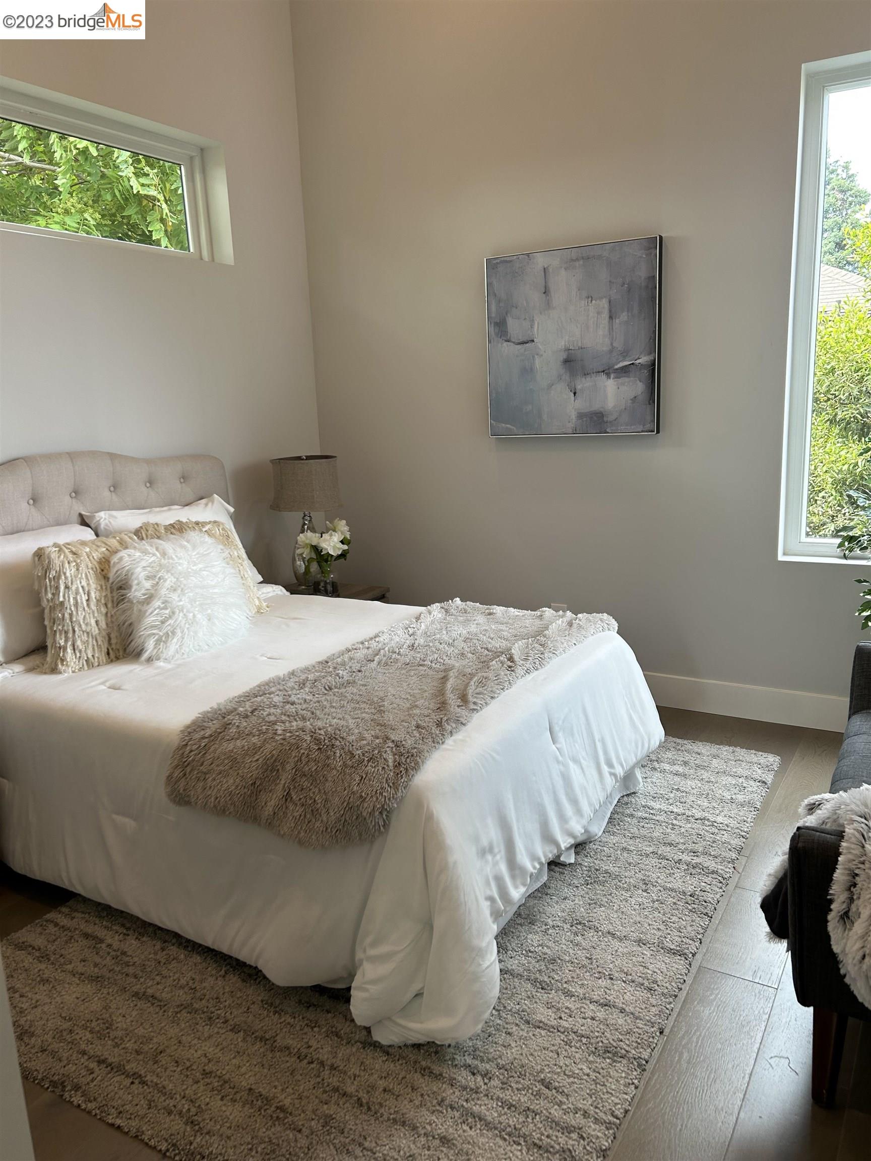 1677 12th Street Oakland, CA 94607 - Photo 7 of 15 a bedroom with a bed and a window