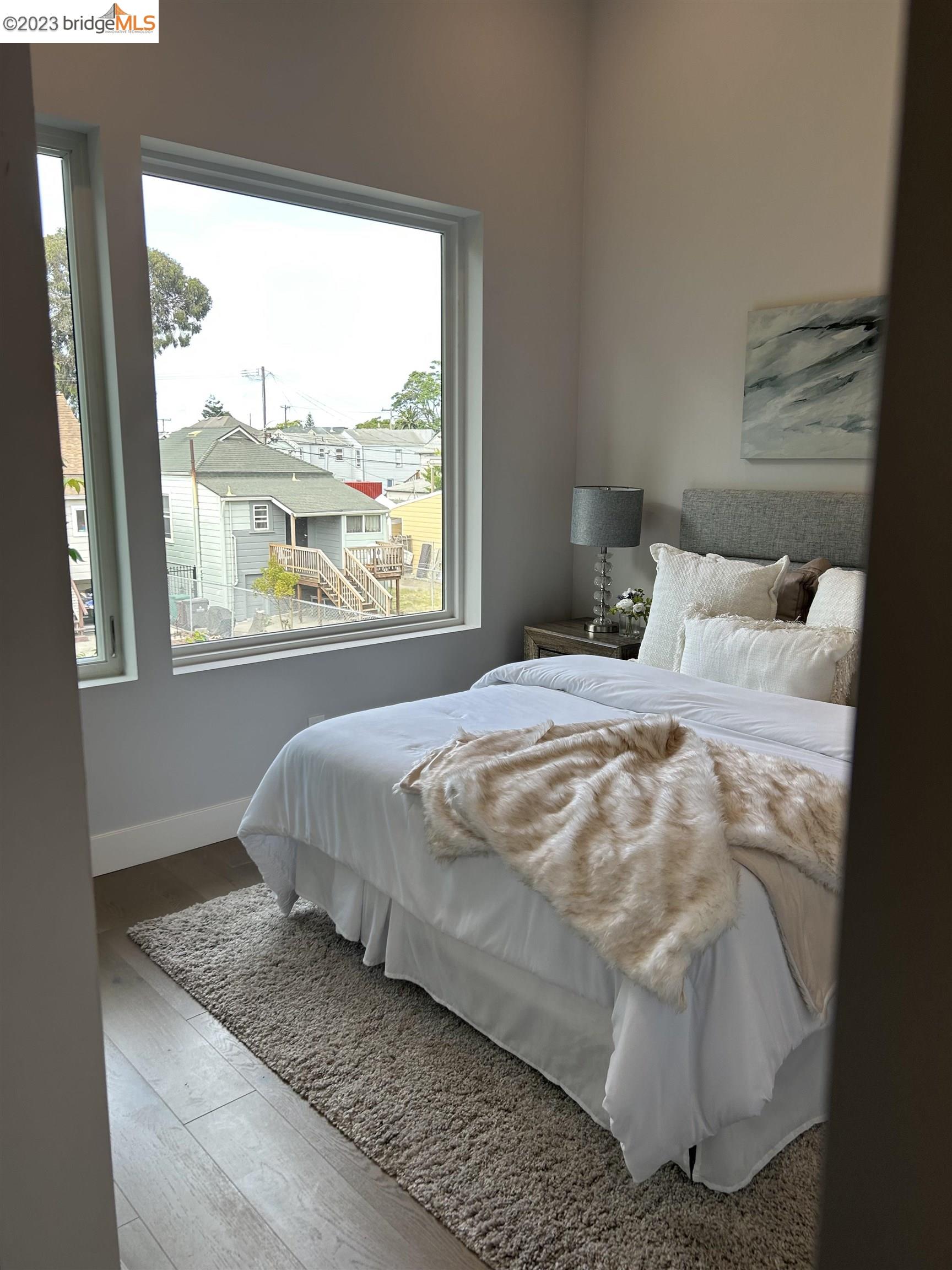1677 12th Street Oakland, CA 94607 - Photo 9 of 15 a bedroom with a bed and window