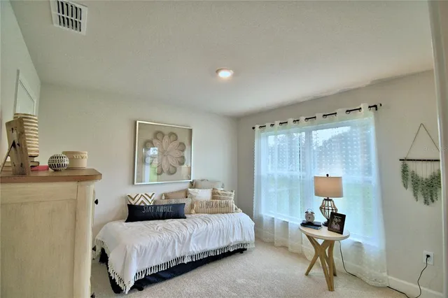 a bedroom with a bed and a mirror