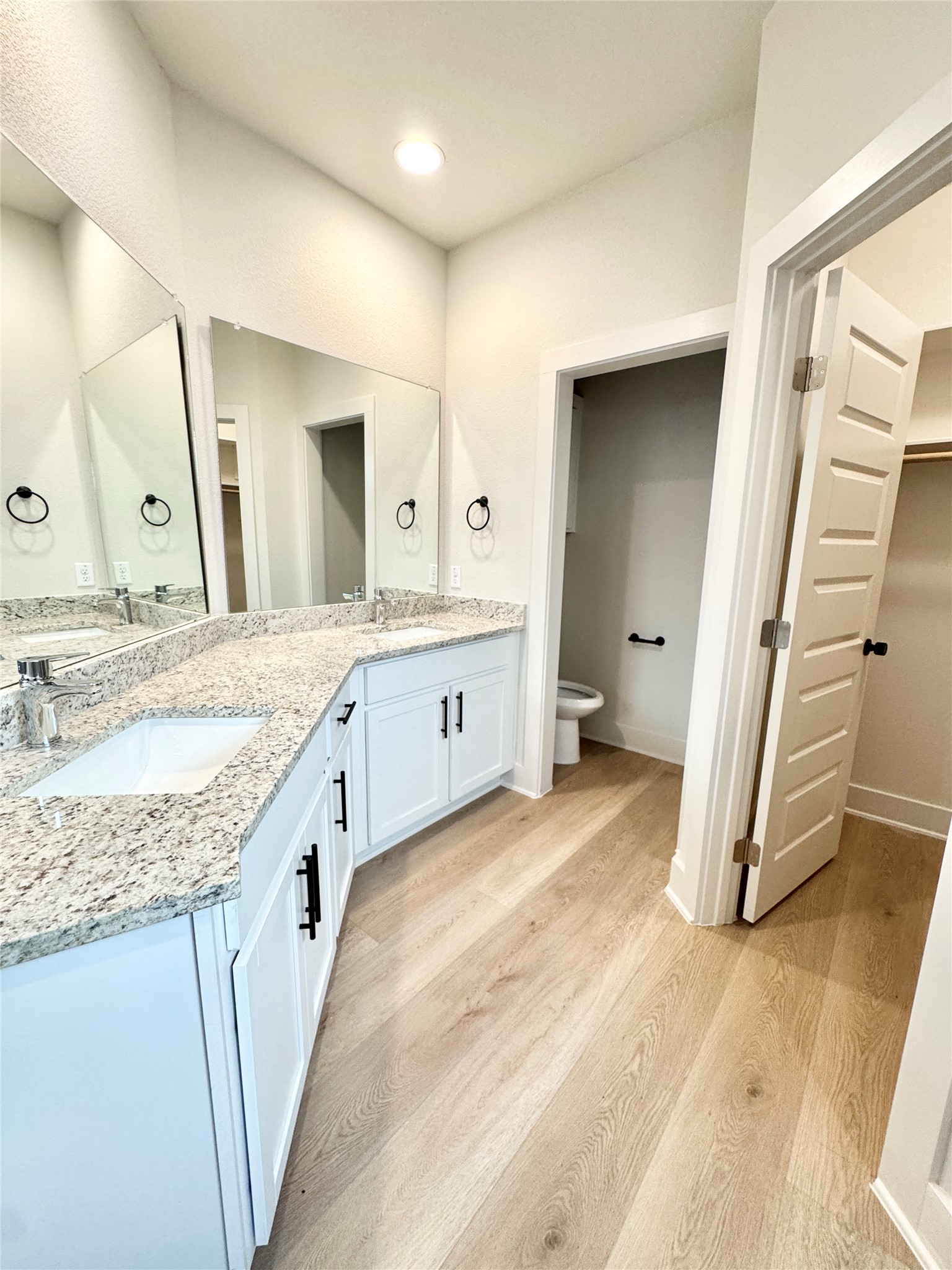 108 Zayd Court, Unit B Jarrell, TX 76537 - Photo 11 of 21 a spacious bathroom with a granite countertop sink a mirror and a vanity