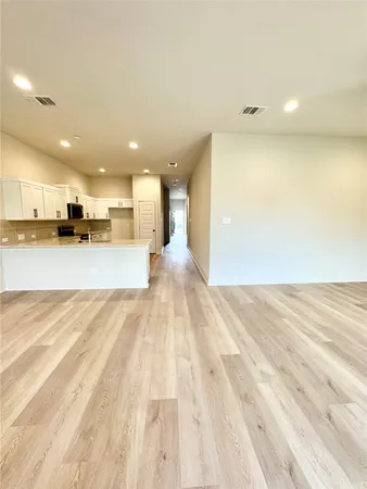 a view of a kitchen with a sink and cabinets