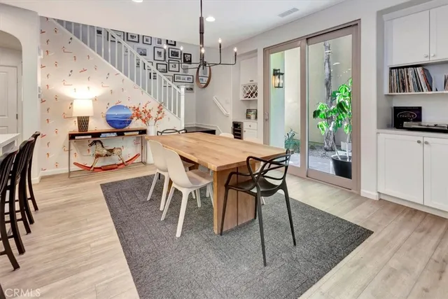 a view of a dining room with furniture and a book shelf