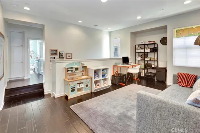 a bedroom with furniture and a wooden floor