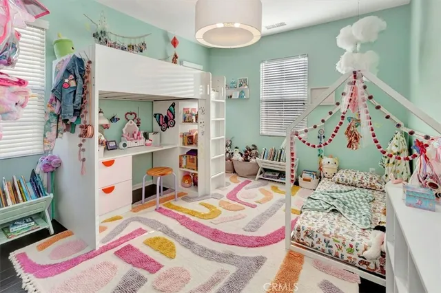 a bedroom with furniture and a baby crib