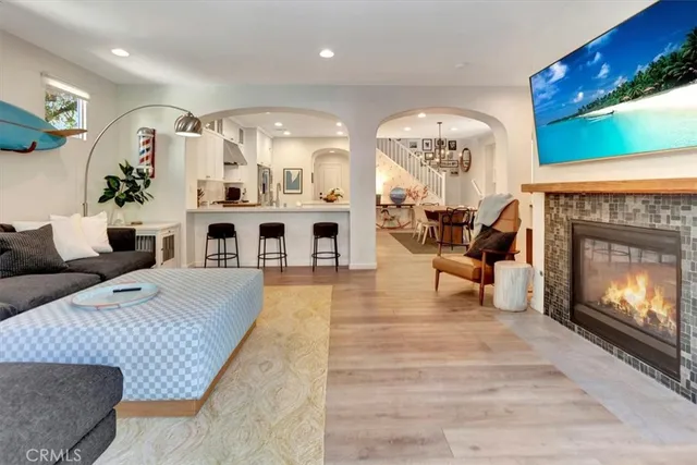 a living room with furniture fireplace and window