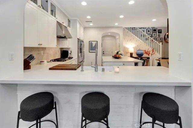 a kitchen with stainless steel appliances a sink and cabinets