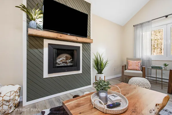 a living room with furniture and a fireplace
