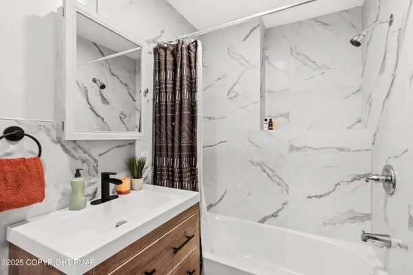 a bathroom with a bathtub and shower
