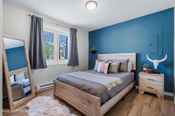 a bedroom with a bed and wooden floor