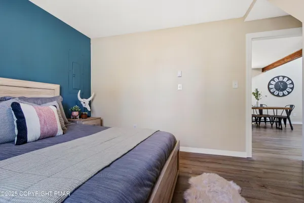 a bedroom with a bed and table