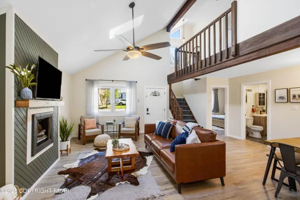 a living room with furniture a fireplace and a flat screen tv