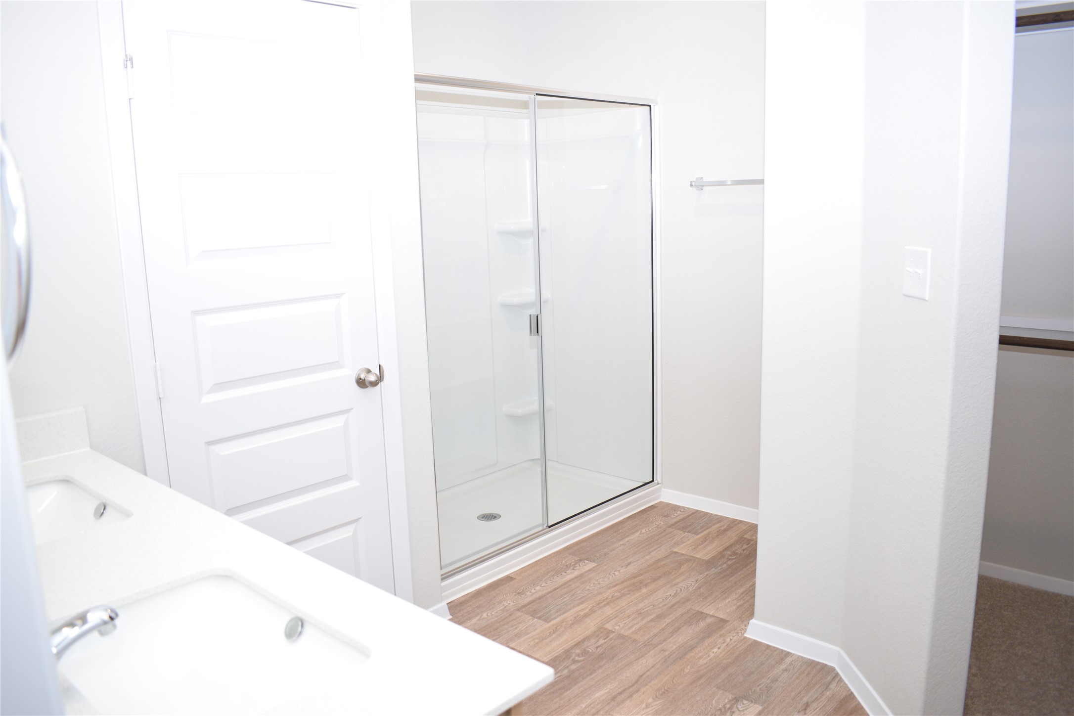 2705 Towy Road Manor, TX 78653 - Photo 12 of 30 Full bath with double vanity, a stall shower, and light wood-style flooring