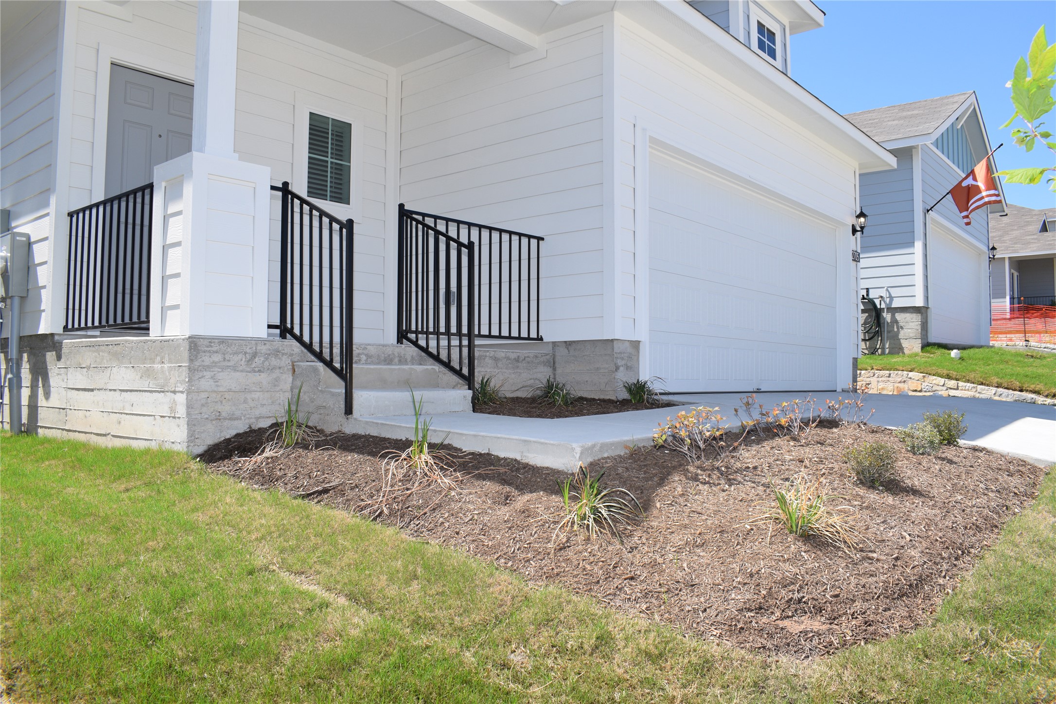 2705 Towy Road Manor, TX 78653 - Photo 2 of 30 View of property exterior with a porch, concrete driveway, and a garage