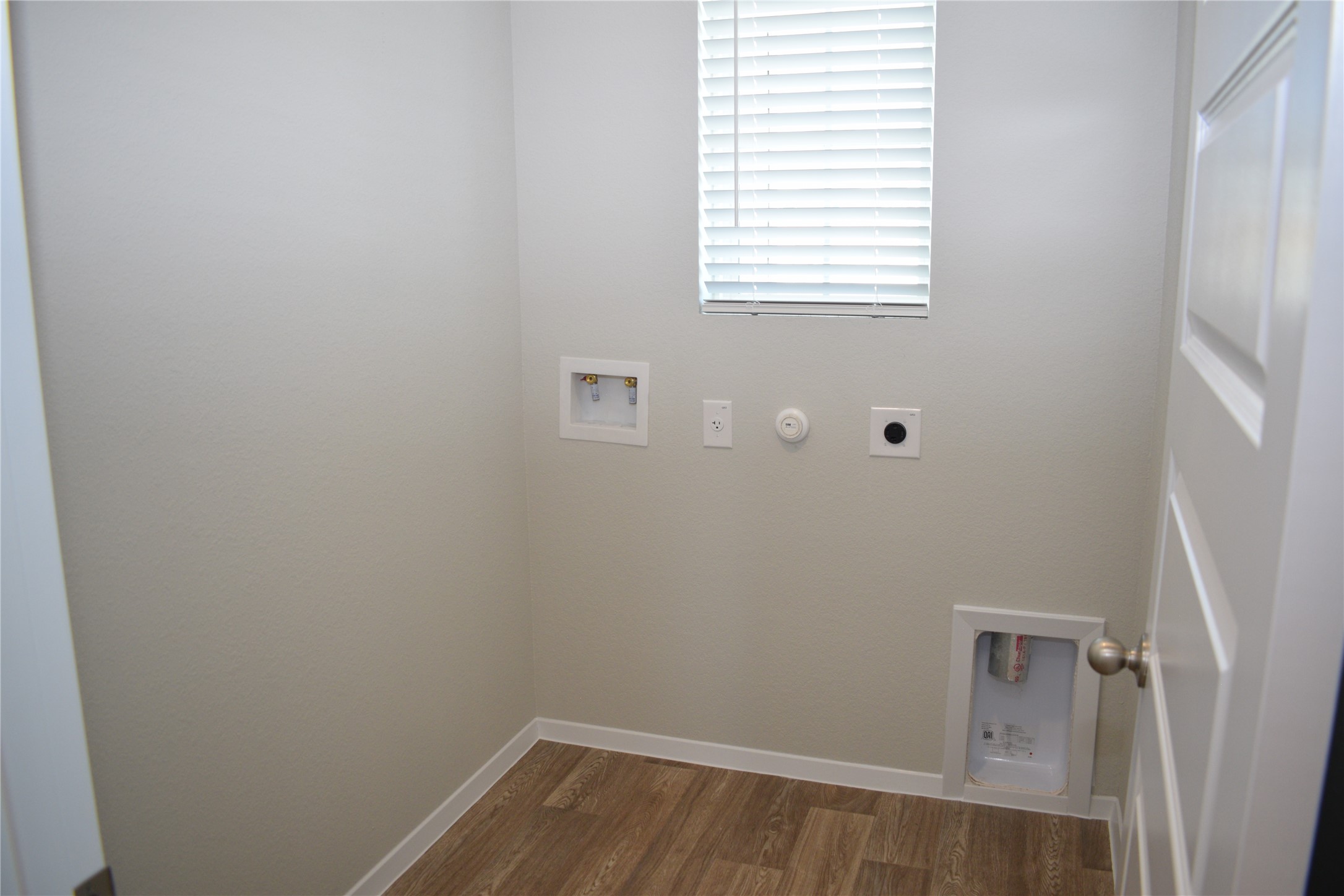 2705 Towy Road Manor, TX 78653 - Photo 19 of 30 Laundry area featuring washer hookup, dark wood-style flooring, hookup for a gas dryer, and electric dryer hookup