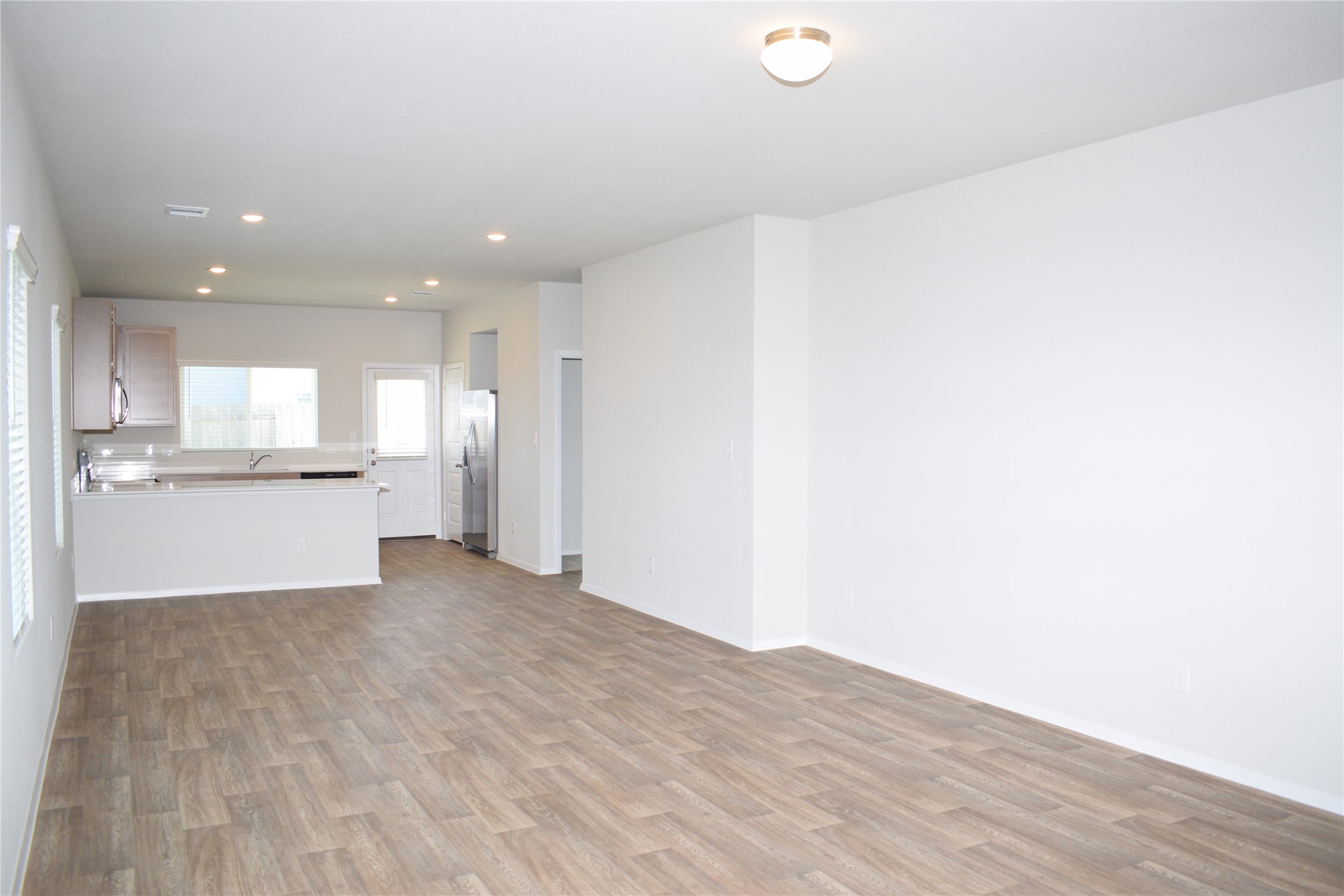 2705 Towy Road Manor, TX 78653 - Photo 4 of 30 Unfurnished living room featuring light wood finished floors and recessed lighting