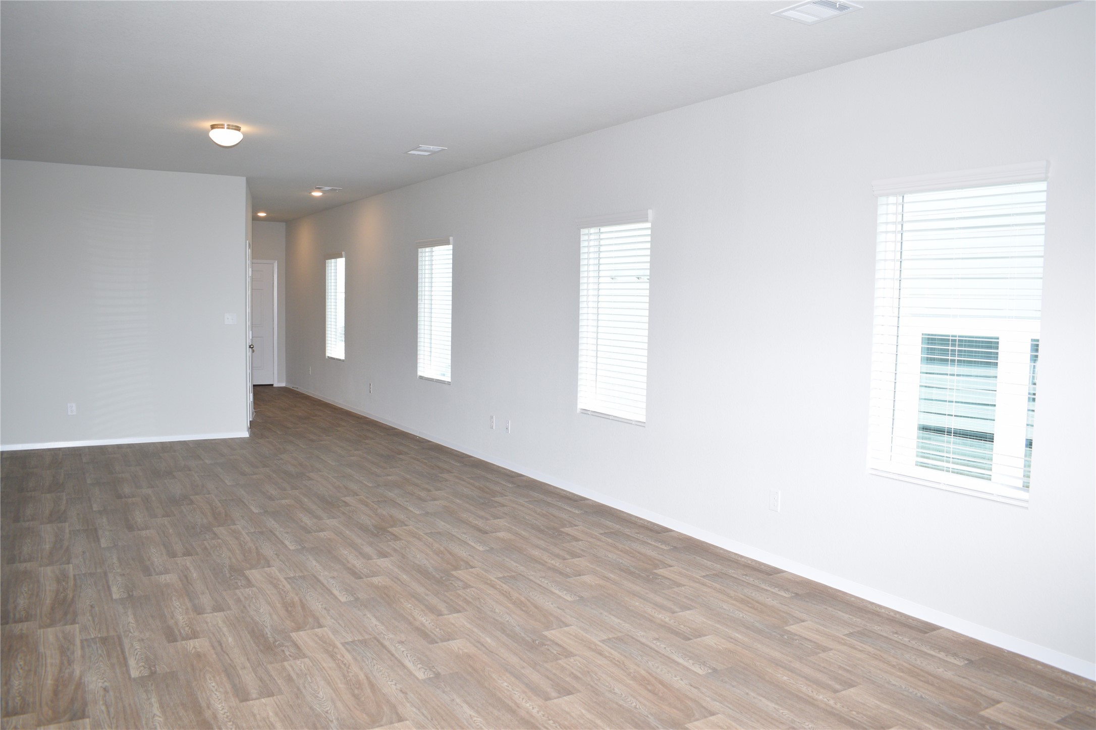 2705 Towy Road Manor, TX 78653 - Photo 5 of 30 Spare room featuring wood finished floors and baseboards