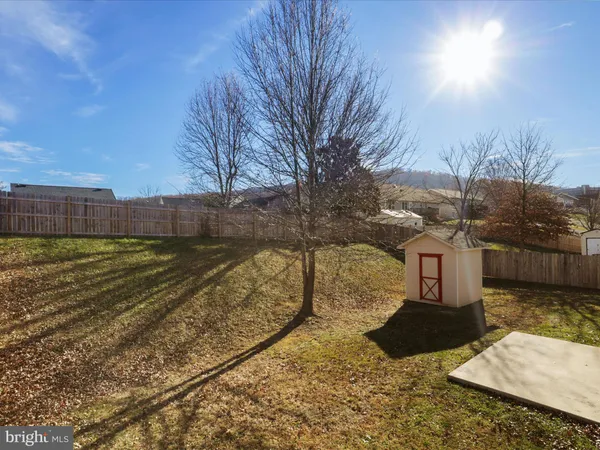a view of a backyard with wooden fence