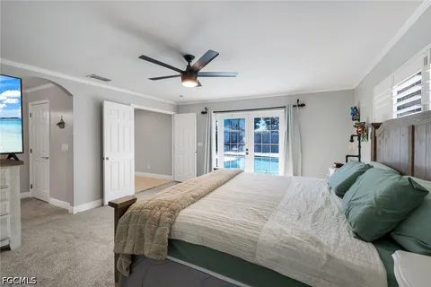 a bedroom with a large bed and a window