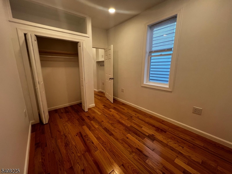 3 Montclair Avenue Paterson, NJ 07503 - Photo 12 of 17 a view of an empty room with wooden floor and a window