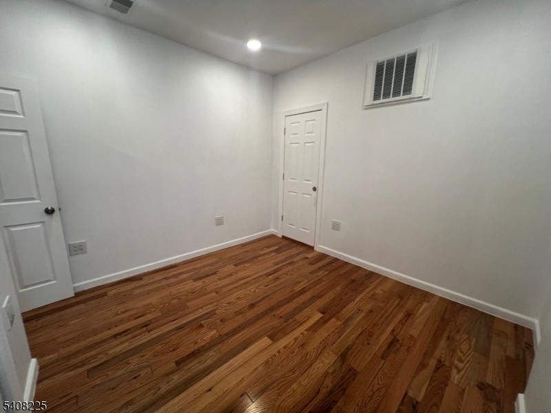 3 Montclair Avenue Paterson, NJ 07503 - Photo 14 of 17 a view of room with wooden floor and window