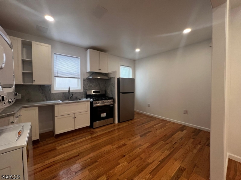 3 Montclair Avenue Paterson, NJ 07503 - Photo 6 of 17 a kitchen with granite countertop a refrigerator stove top oven and sink