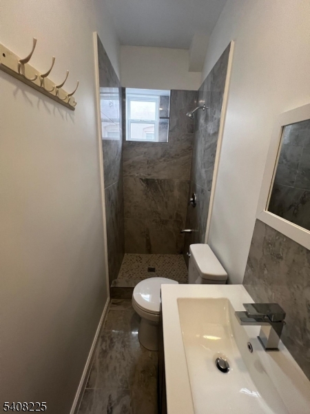 3 Montclair Avenue Paterson, NJ 07503 - Photo 10 of 17 a bathroom with a sink and toilet