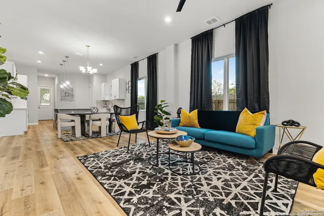 a living room with furniture a rug and a chandelier